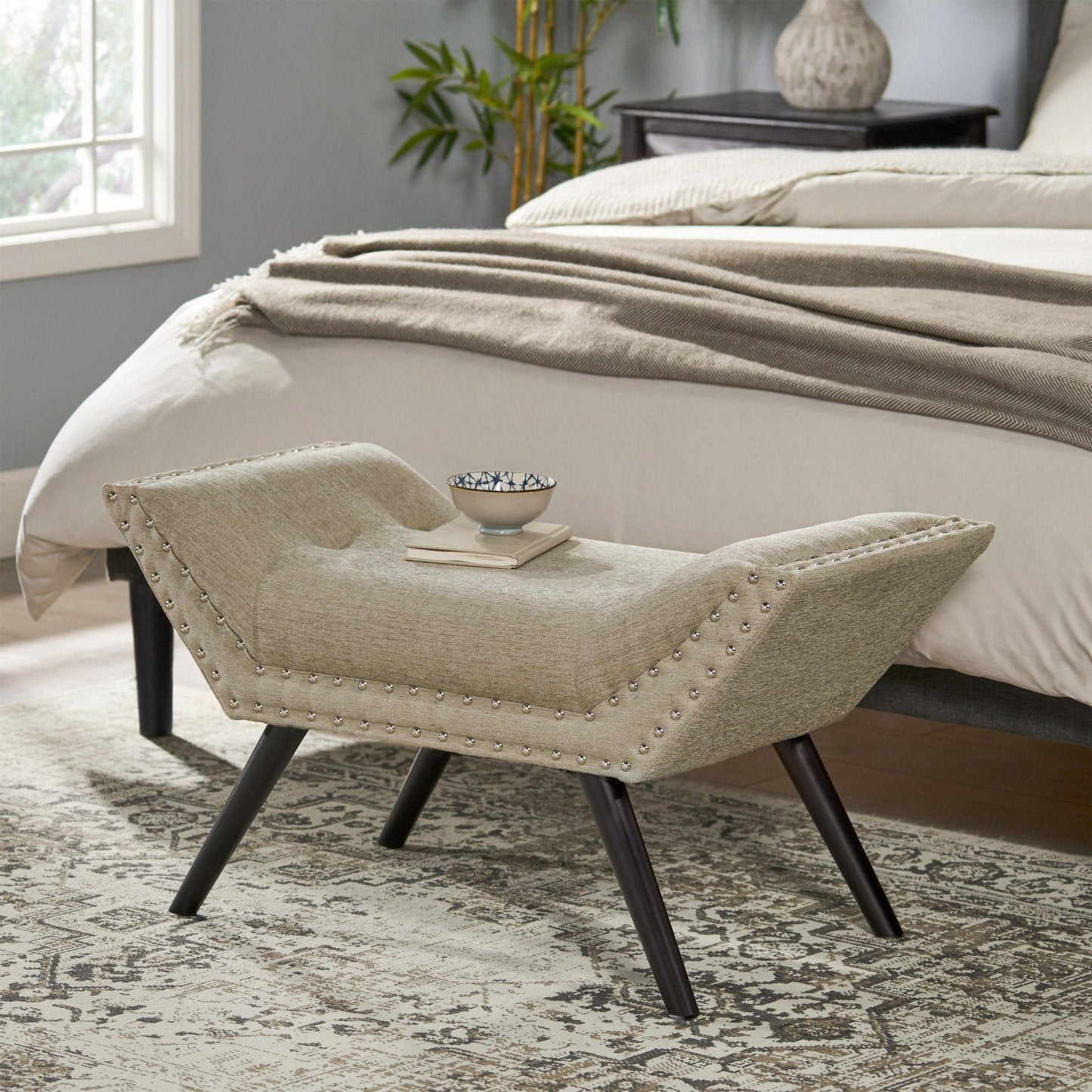 Upholstered Ottoman with Nail Head Trim and Flared Arm