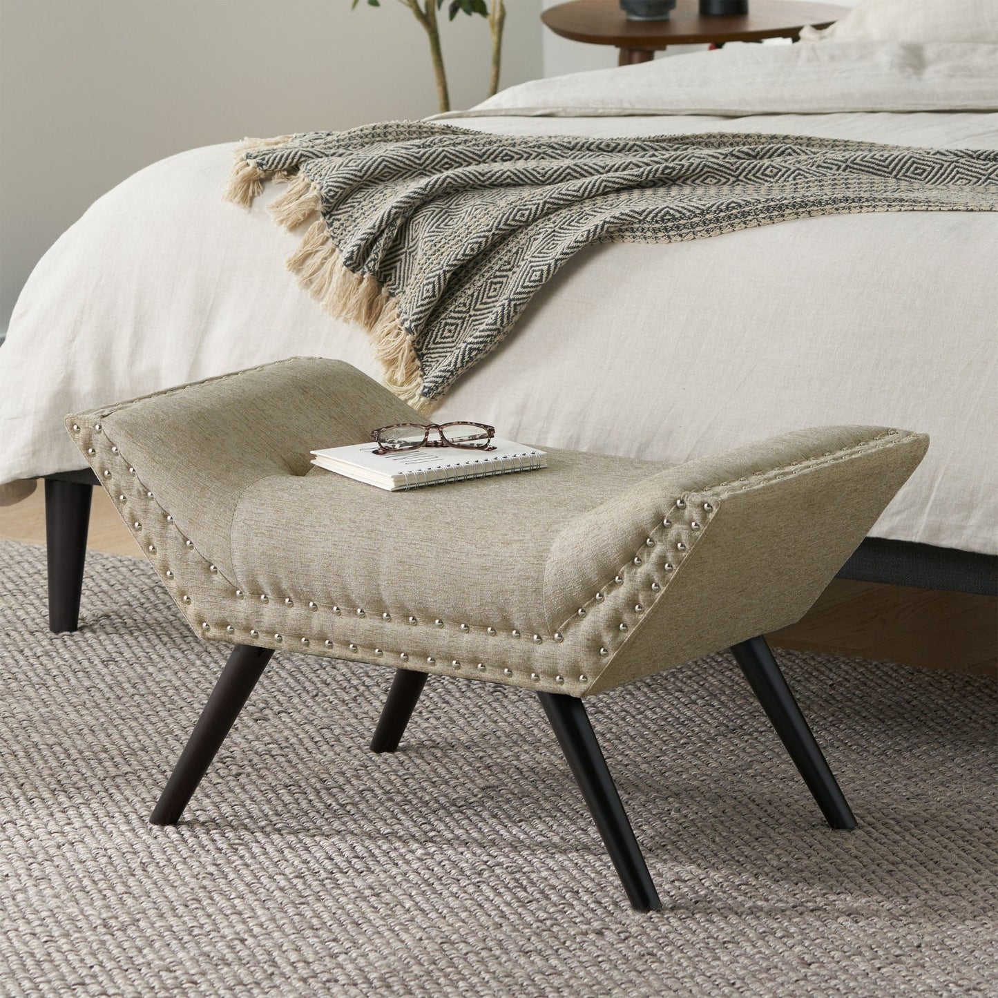 Upholstered Ottoman with Nail Head Trim and Flared Arm