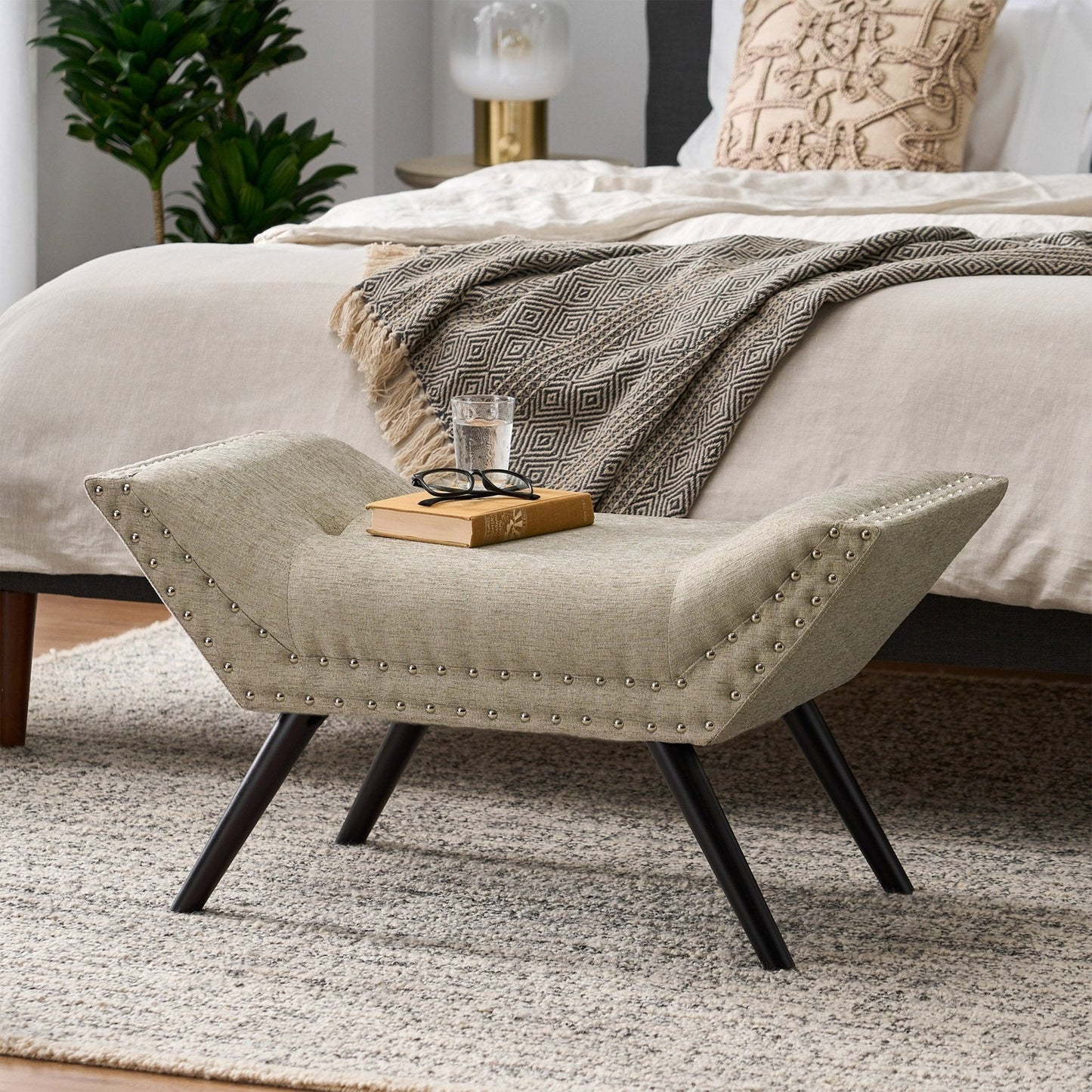 Upholstered Ottoman with Nail Head Trim and Flared Arm